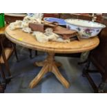 A modern pine circular topped kitchen dining table having a turned column and on four legs 73.5cm