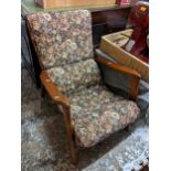 A mid 20th century floral upholstered and teak framed armchair Location: