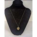 A 9ct gold heart shaped locket on a stamped 9ct chain link necklace, total weight 3.8g Location: