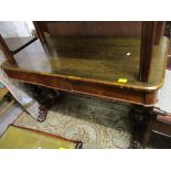 An early 19th century Regency rosewood library table on octagonal baluster column supports and