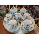A Limoges teaset for four consisting of teapot, sugar bowl, milk jug, tray, cups and saucers