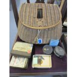An early 20th century wicker fishing creel containing a J W Young & Sons Pridex fishing reel, a