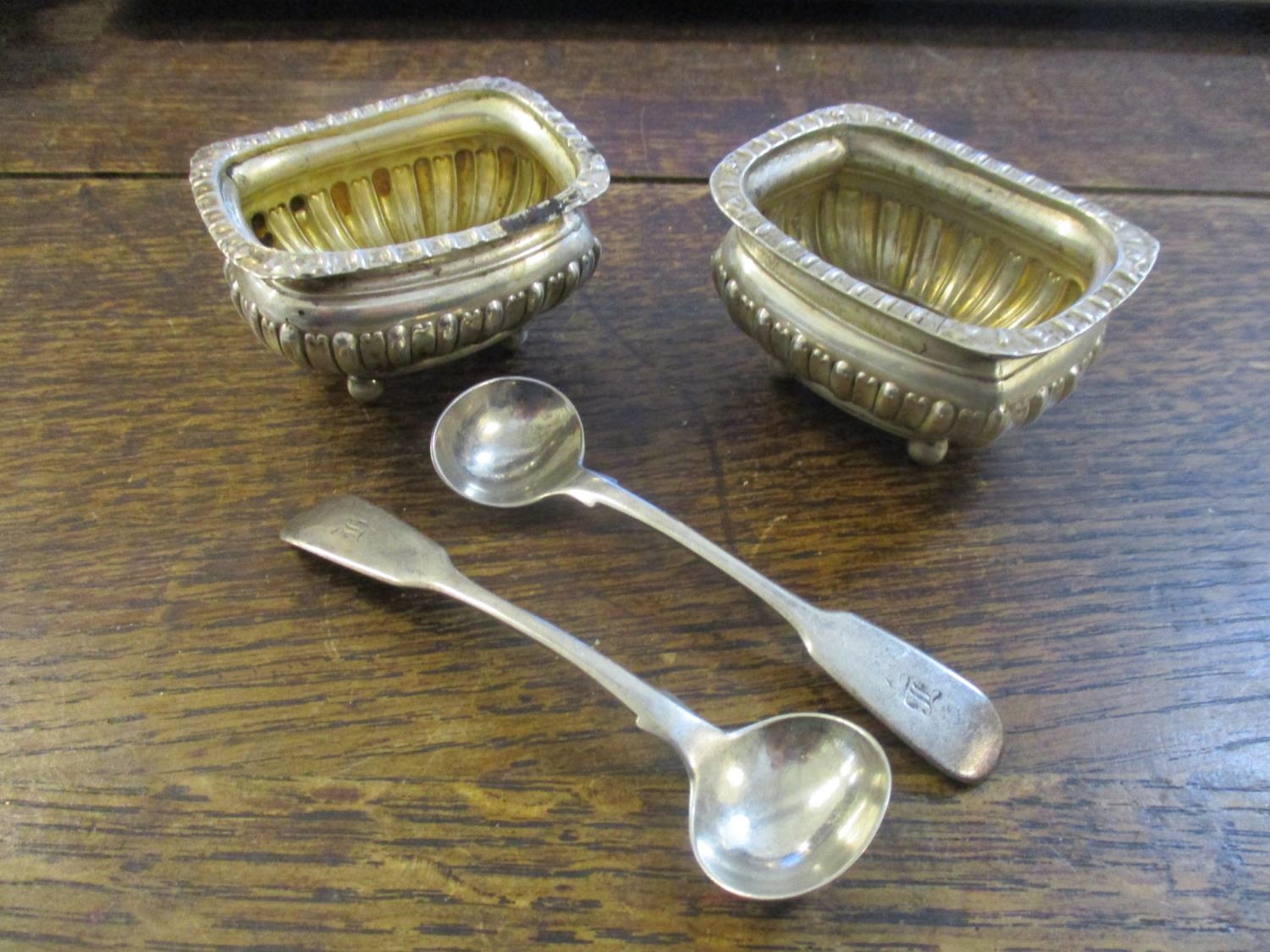 A pair of Victorian silver salts with fluted top rim and lower half of body, on ball feet, Chester