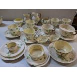A selection of Belleek Clover pattern china to include a moustache cup, milk jugs, cups and saucer