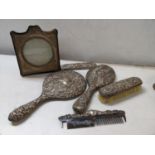 An early 20th century silver photograph frame together with a silver dressing table set A/F
