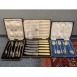 A cased set of silver teaspoons together with a cased set of silver plated forks and knives