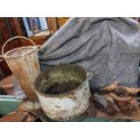 Garden related items to include a metal duck, a small birdbath, a cast metal cauldron on a stand,