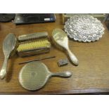 A selection of silver clad dressing table brushes, a comb (without teeth), and a hand mirror (