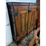 An early 19th century mahogany large German breakfront cabinet with a dentil moulded cornice above a