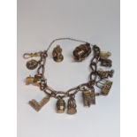 A 9ct gold curb link charm bracelet having eleven various charms to include The Palace of