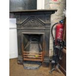 An Edwardian cast iron fire place, 99cm h x 77cm w, with fireside implements Location:
