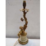 A mid 20th century gilt metal table lamp in the form of a cherub leaning against a floral vine, 42cm