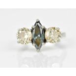 A platinum, diamond and blue diamond ring, with central marquise cut blue diamond flanked with a