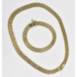 An Italian 9ct yellow gold necklace and matching bracelet, with articulated flat brick links, with