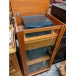 A Technics stereo stacking system in a vintage teak cabinet together with mixed records to include