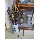 A modern Oriental blue and white porcelain stick stand containing various umbrella, ski poles and