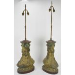 A pair of Chinese heavy bronze lamps in the archaic design, of baluster form supported on wooden