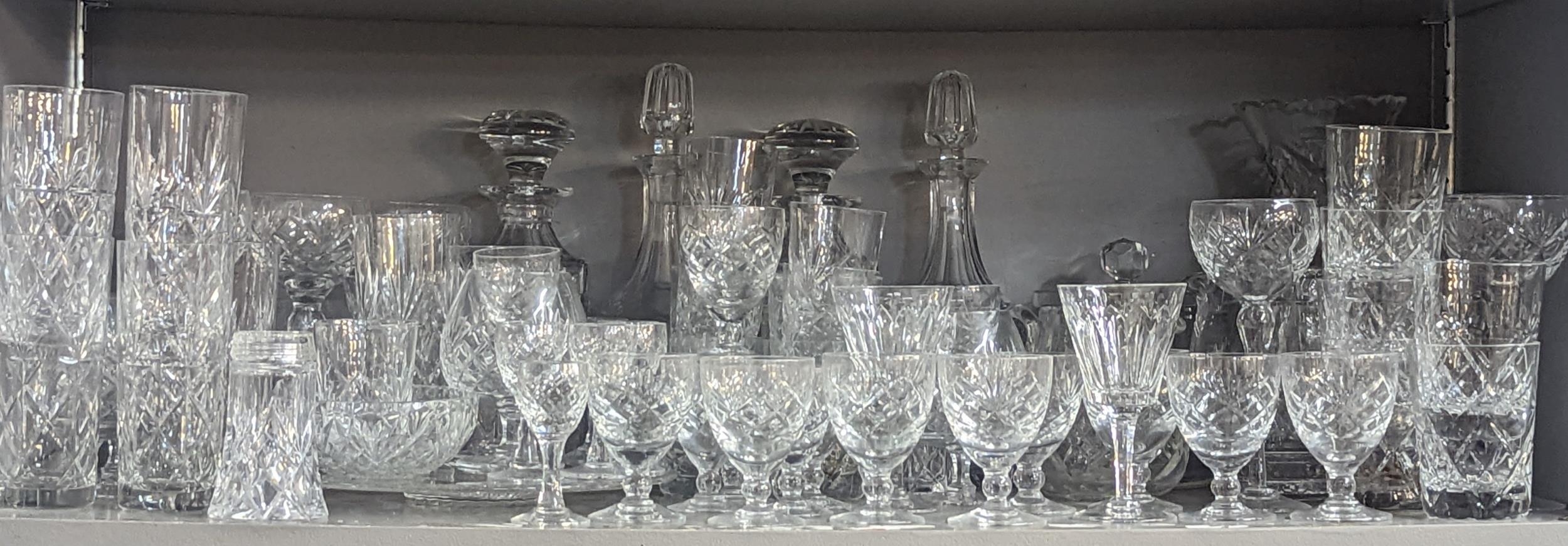 A group of domestic glassware to include cut glass decanters, cups, dishes, bowls and others