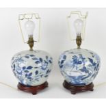 A pair of Chinese Qing dynasty celadon porcelain lamps, 19th century, with blue and white peony