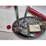 A silver plated and galleried tray with contents to include three silver decanter labels; Brandy,