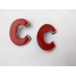 Two vintage red, white and blue brooches in the form of a letter 'C' Location: CAB