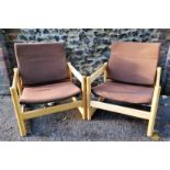 A pair of 1970s beech armchairs, in the Parker Knoll style, the back rest and seat cushion in