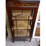 An Edwardian mahogany display cabinet with painted floral decoration, glazed door with fabric