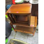 A retro teak trolley, together with a retro teak nest of three tables Location: