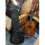 A Yamaha acoustic guitar together with case and stand Location: