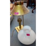 A brass table lamp in the form of an oil lamp having an additional milk glass shade and another