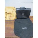 Hugo Boss-A black leather briefcase in branded dustbag with key together with a light brown