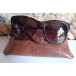 Ralph Lauren-A pair of ladies brown tortoiseshell effect sunglasses with gold tone ornate metal