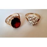 Two 9ct gold dress rings, one set with white cabochons and the other with a large garnet, total