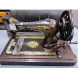 An 1870's Singer sewing machine in oak case, serial number 12059692 Location: