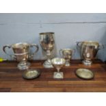 Five large silver trophies, three of them engraved with agricultural and cow related inscriptions,