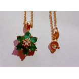 A 14ct gold chain and a 14ct gold and 6 emerald stone pendant in the form of a flower, total