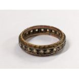 A yellow and white metal eternity band inset with paste stones, 3.3g Location: CAB5