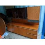 A mid 20th century McIntosh teak highboard having smoked glass doors and on a plinth base, 140cm h x