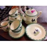 A German Zeller Fayenzerie yellow glazed tea set with images of black cockerels, 4 setting, no sugar