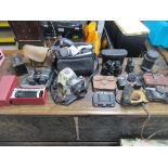 A selection of vintage film cameras, camera accessories, and cased binoculars to include a Nettar