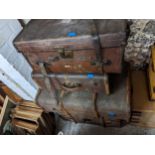 Four canvas and wooden trunks with metal strapwork, one with a brass lock Location: G