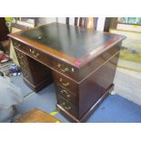 A late 19th century mahogany twin pedestal writing desk having a leather topped scriber and pine