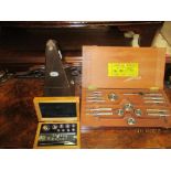 A lot to include a Paquet wooden cased metronome, a set of German chemist scale weights, boxed,