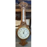 An early 20th century oak carved aneroid barometer, the dial inscribed R.J Whitehall Newport, 96cm h