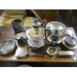 A quantity of mixed silver plated items to include a wine bottle holder, bread board, rose bowl