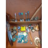 A small vintage brown leather suitcase and contents to include badges, collectors spoon, one