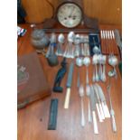 Silver plated and other cutlery and flatware, a mid 20th century oak cased mantel clock, two brass