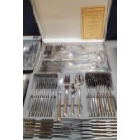 An SBS Bestecke Solingen 12-setting cutlery set in a gold and silver colour housed in a silver