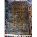 Two rugs to include a handwoven Middle Eastern rug with elephant foot motifs, 155cm x 93cm, together