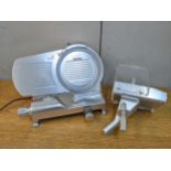 A metal electric meat slicer with a continental plug Location: